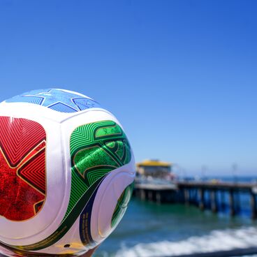 FIFA World Cup promo ball pier and ocean in the background