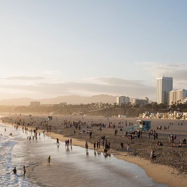 Santa Monica Beach at Sunset with People  and Lifeguard Towers