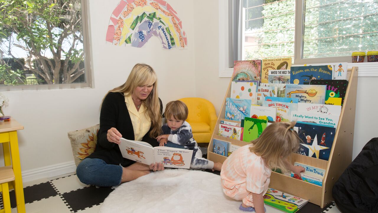 Woman reading a book to children at Sunny Days Preschool