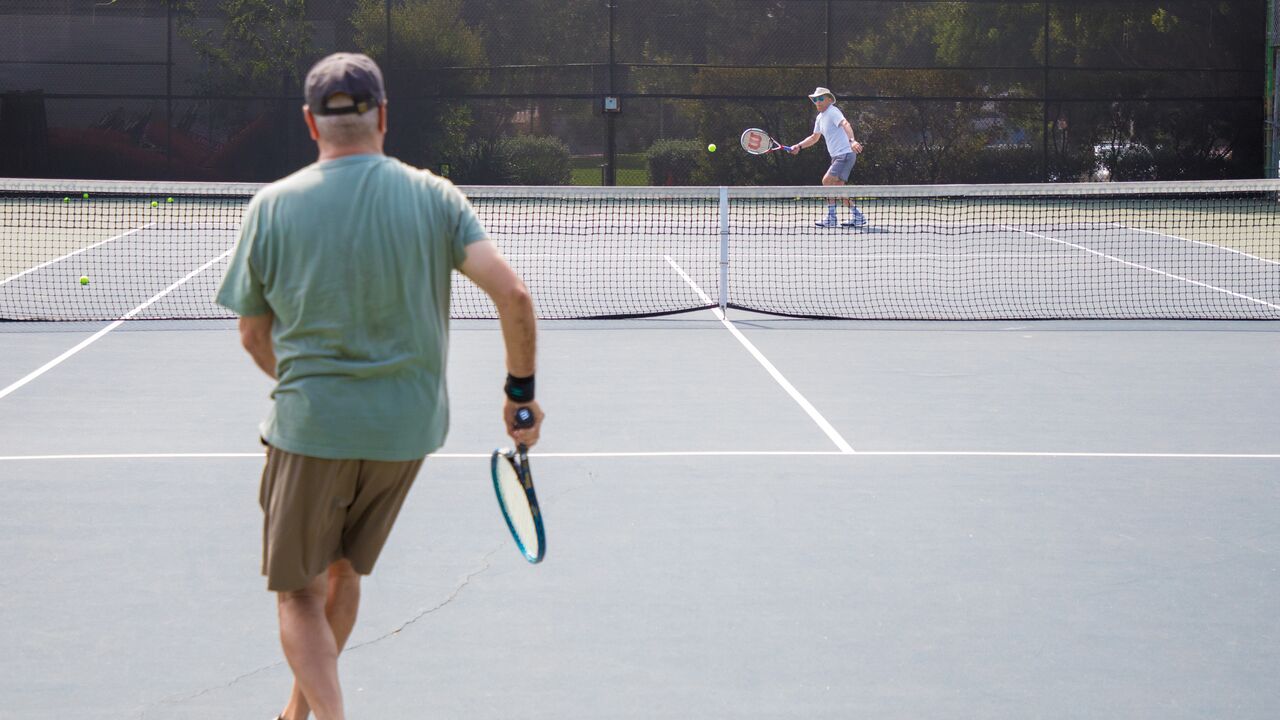 Two People Playing Tennis at Douglas Park Tennis Court