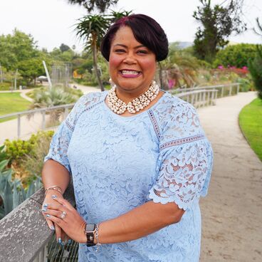 Nikima Newsome Wearing a Blue Dress Standing in Tongva Park