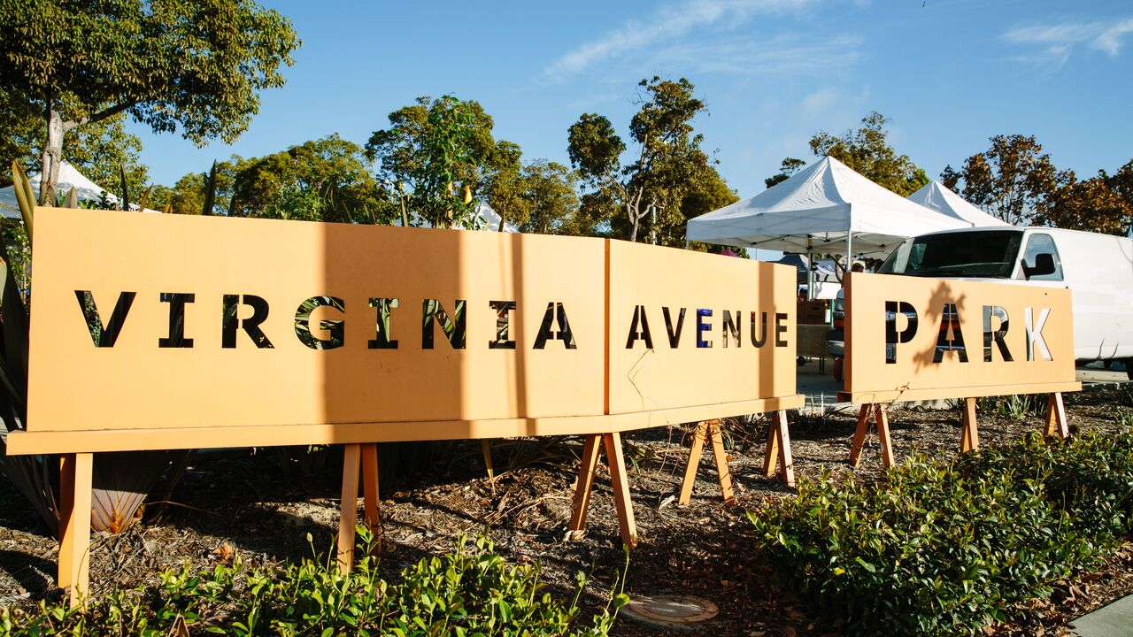 Virginia Avenue Park Sign with Trees and Blue Skies in the Background 