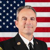 Portrait of Deputy Fire Chief Tom Clemo with United States Flag in the Background