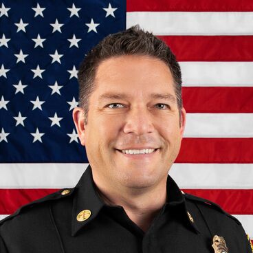 Portrait of Battalion Chief Sean Van Sluis with United States Flag in the Background