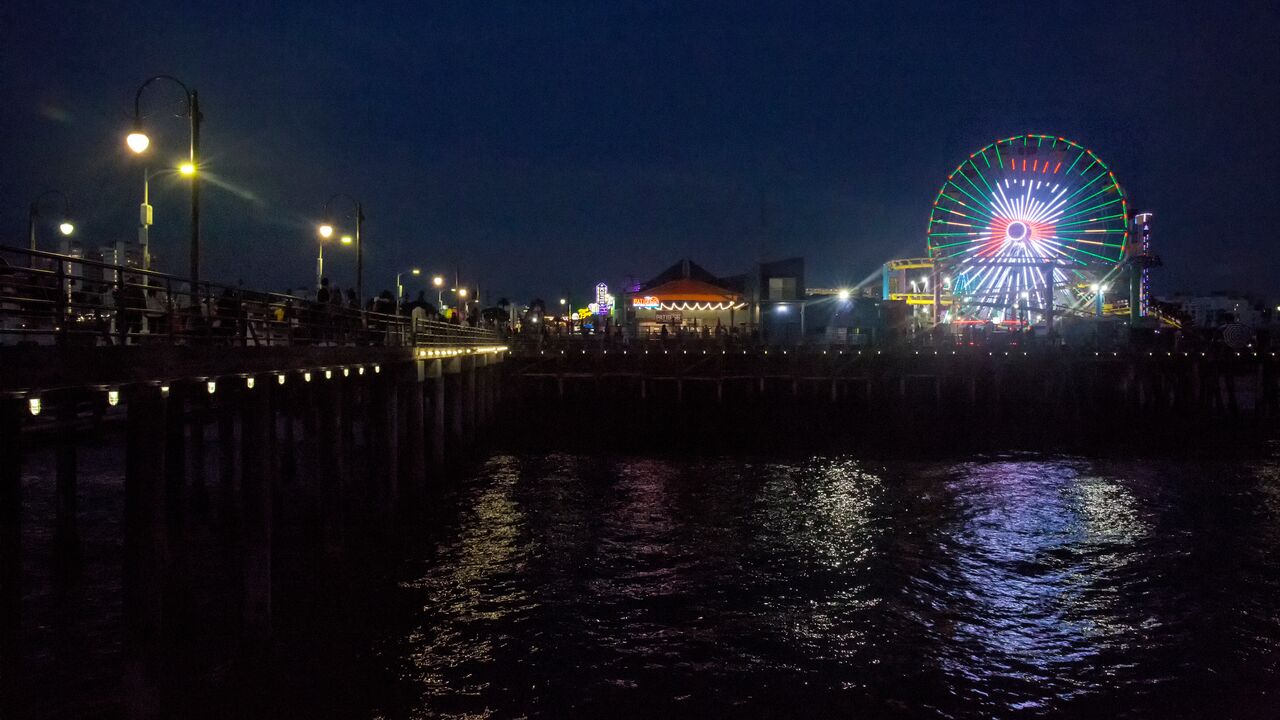 Photo of Pier at night with Carousel lit with a snowman picture