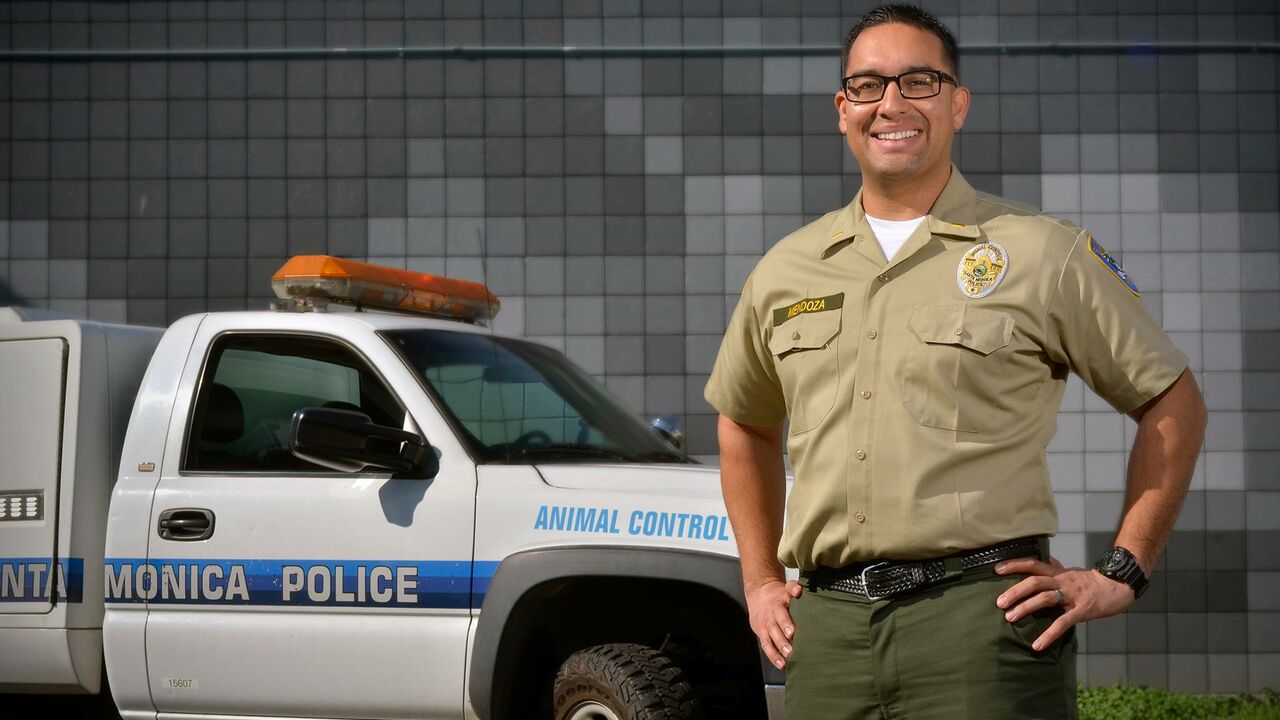 Animal control officer with City truck in background