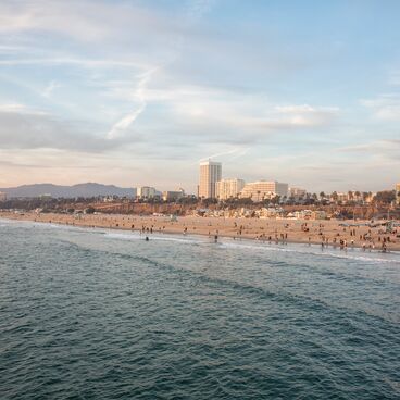 Wide shot of ccean, beach, and Santa Monica skyline