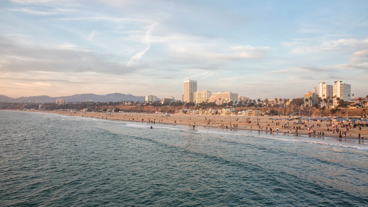 Wide shot of ccean, beach, and Santa Monica skyline