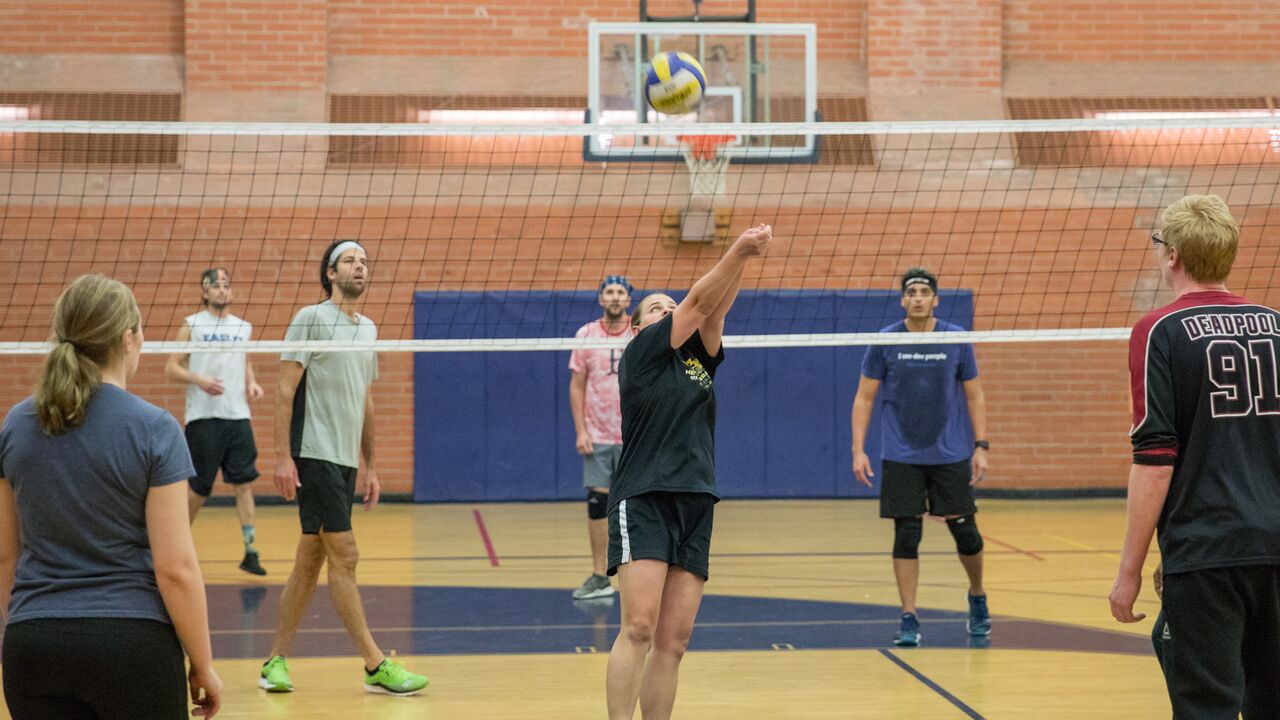 Person bumping a volleyball at Memorial Park gym