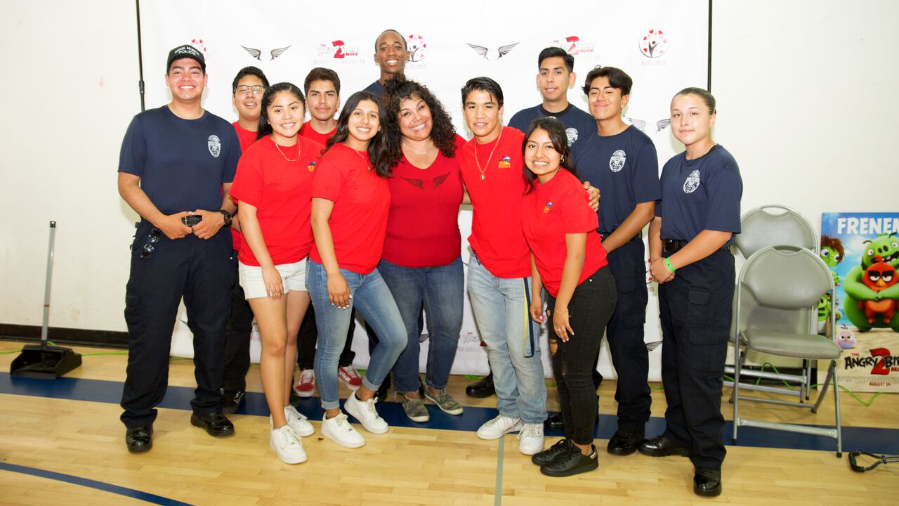 Group of youth posing with police officers at PAL