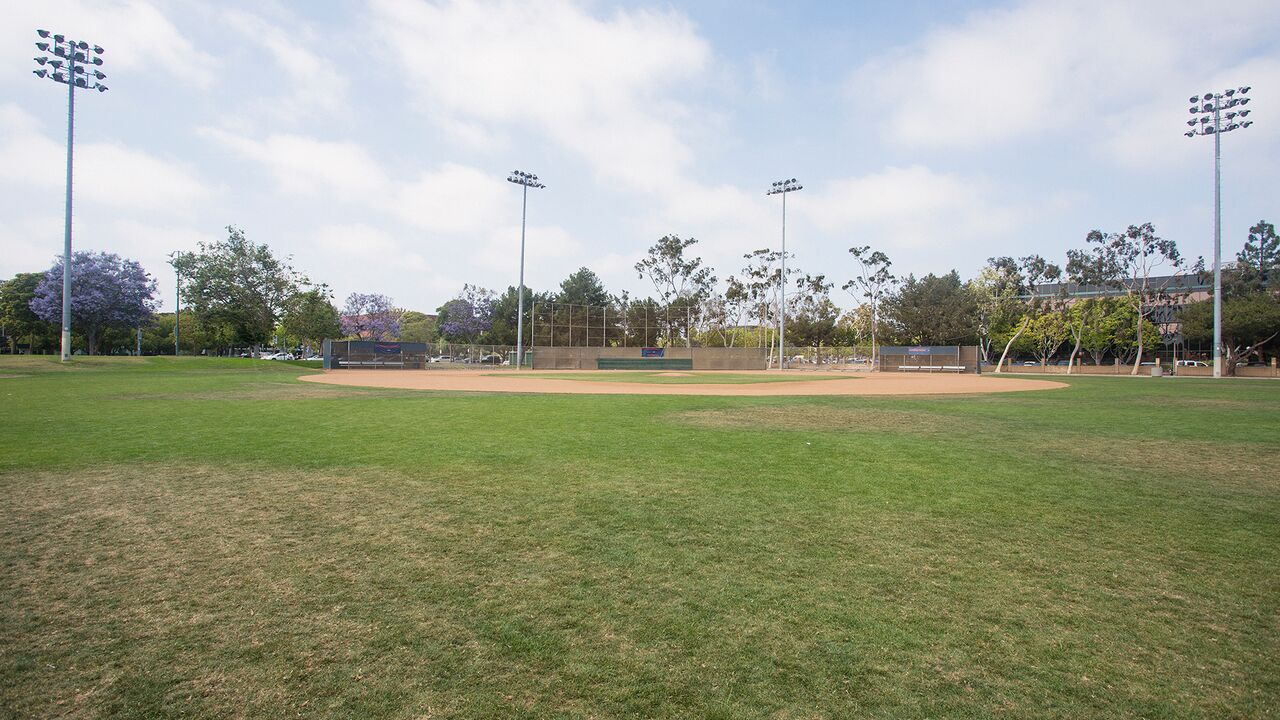 Baseball Field With Large Stadium Lights Surrounding It