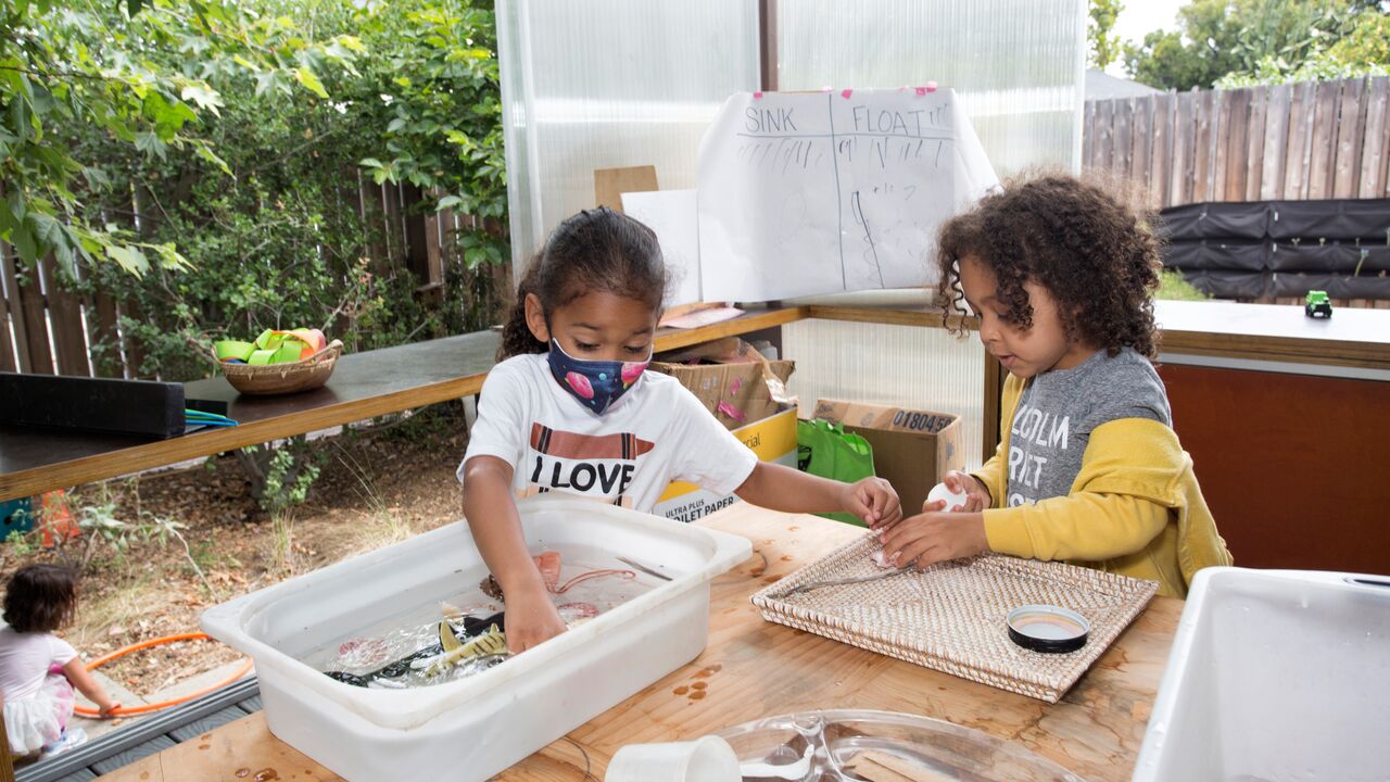 Two Children Playing at Science Project Table at Untitled No. 1 Preschool