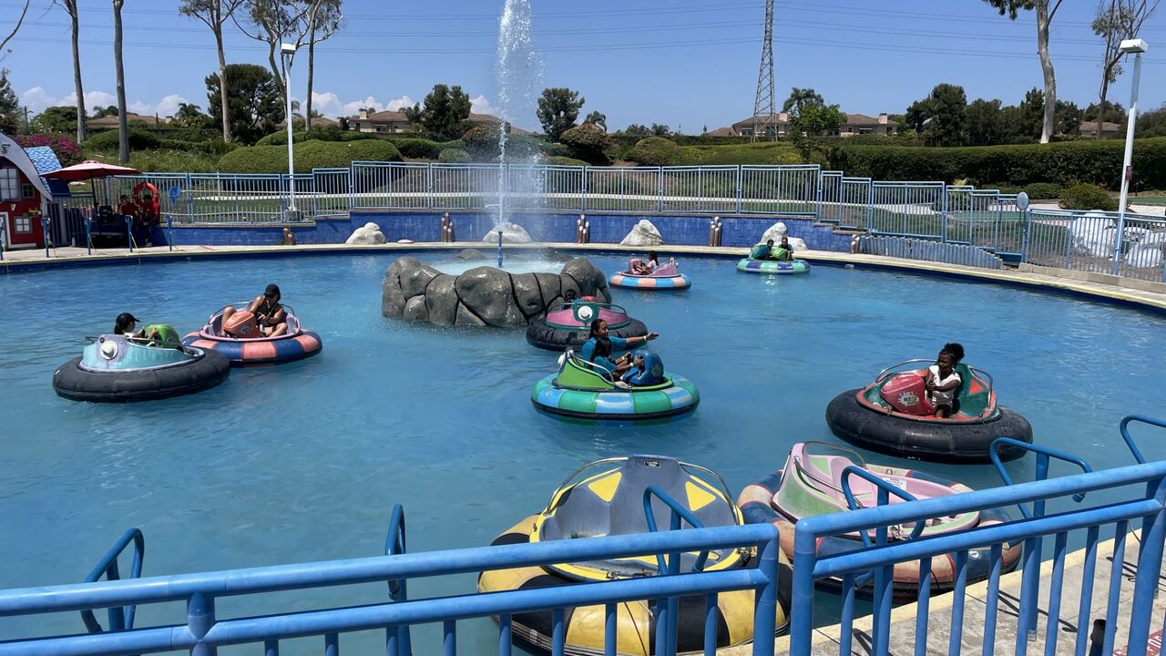 Youth in innertubes at a water park as part of PAL summer camp