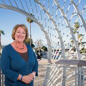 Rent Control Executive Director Tracy Condon in Tongva Park With the Ocean and Palm Trees in the Background