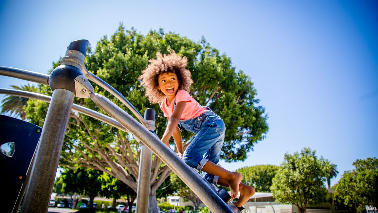 Young Girl Climbing on the Playground